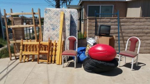 Chairs, mattress, and wood pieces staged at a house