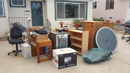 Desks, chairs, and shelves staged in front of an apartment