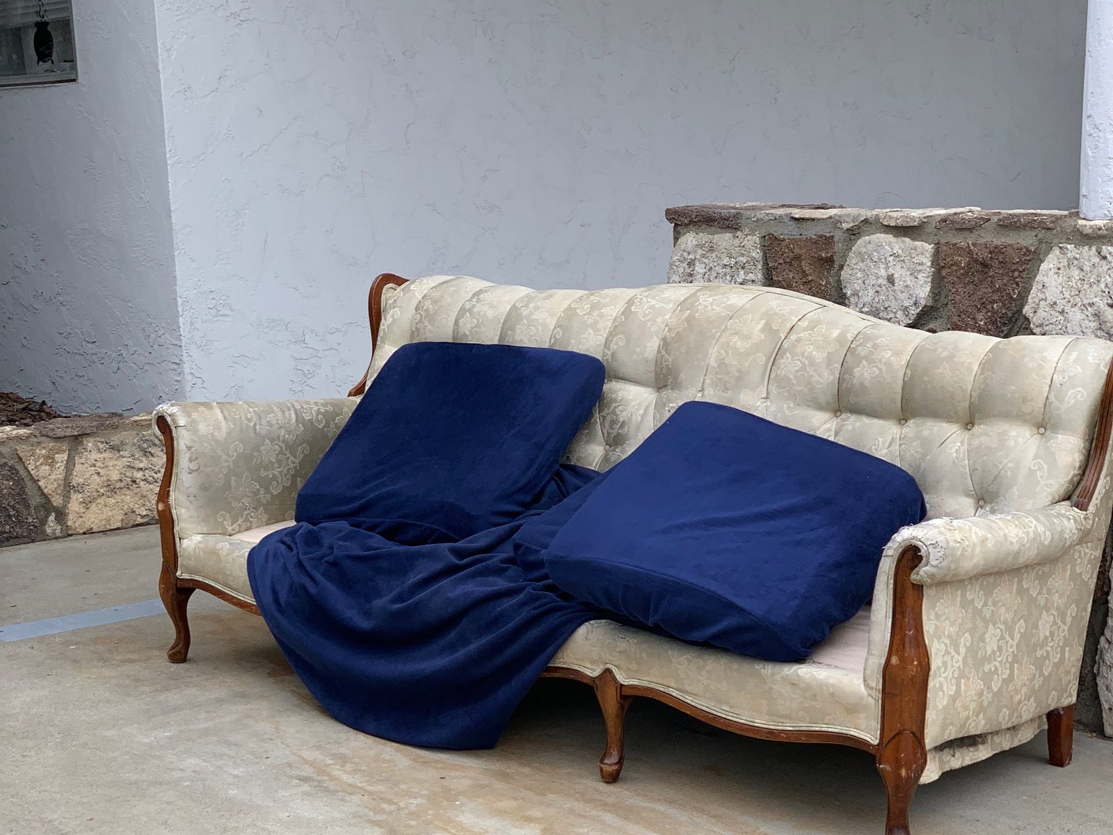 San Diego furniture removal — cream sofa staged at the curb for same-day pickup